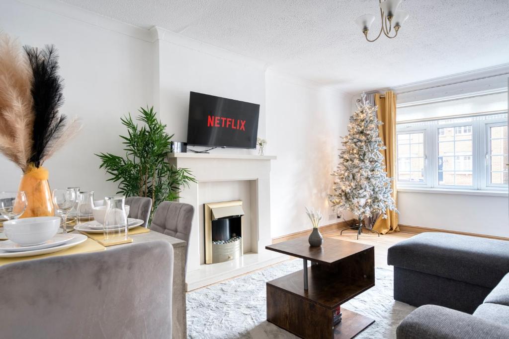 a living room with a fireplace and a christmas tree at LIVERPOOL HOME with FREE PARKING in West Derby