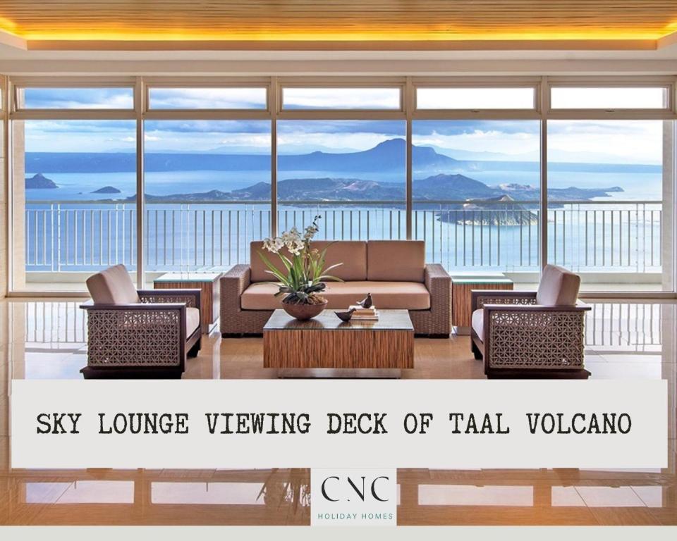 a living room with a view of the ocean at CNC Tagaytay Staycation with Netflix in Tagaytay