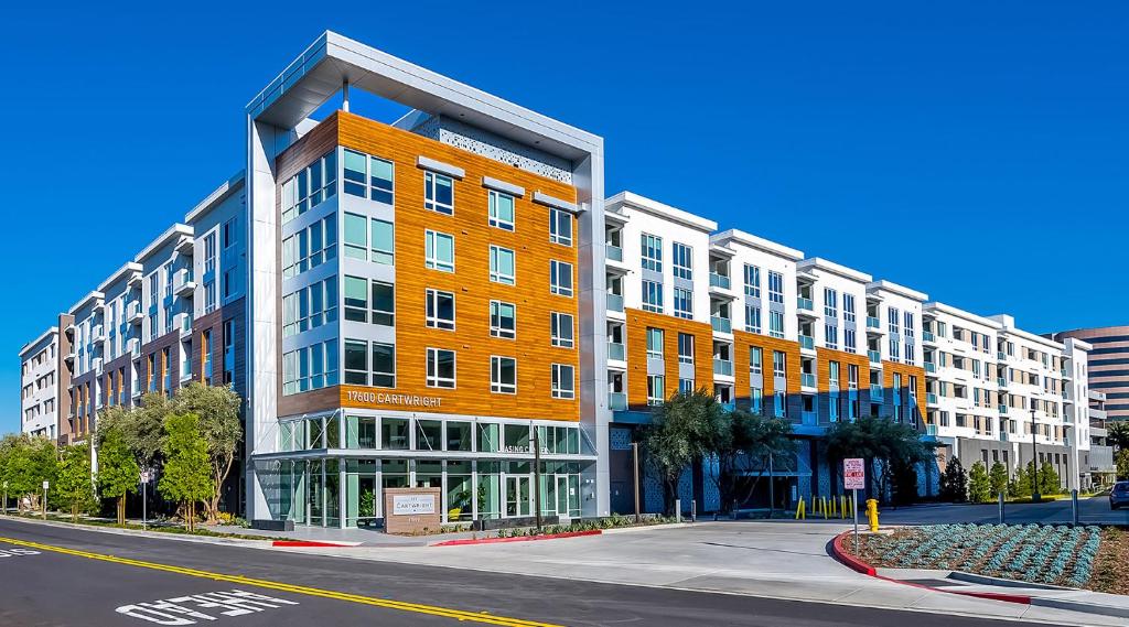 an orange building on a city street with a road at Global Luxury Suites Irvine in Irvine