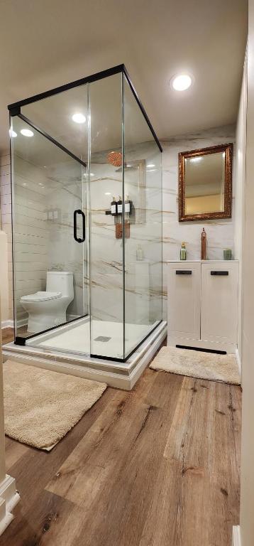 a bathroom with a glass shower and a toilet at Starlight Guesthouse in West Orange