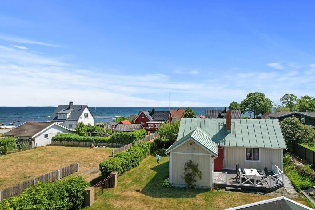 an aerial view of a neighborhood with houses and the ocean at Idylliskt hus med havsutsikt in Sölvesborg
