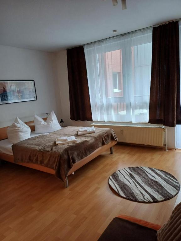 a bedroom with two beds and a large window at Business Apartment in Berlin