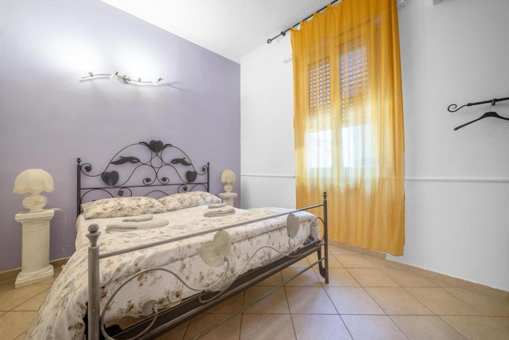 a bedroom with a bed in a room with a window at Villa verdi vicinanze Milano centro in Pioltello