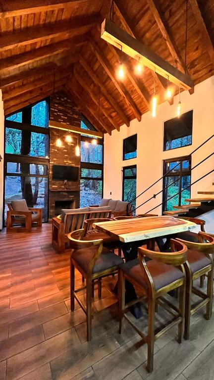 a dining room with a wooden table and chairs at Cabaña Luna Encantada in Mazamitla