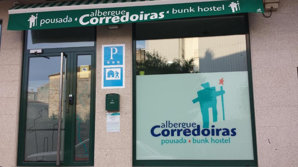 a building with a sign in front of a building at Albergue Corredoiras in Padrón