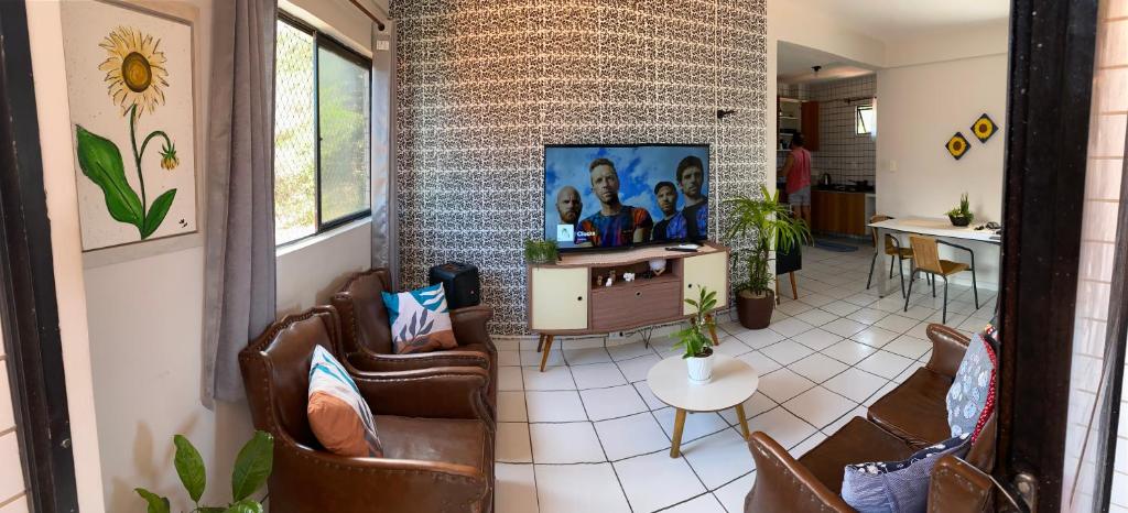 a living room with leather chairs and a table at Edifício Ocean garden in São Luís