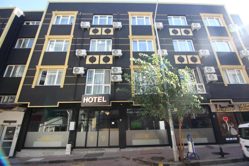 a hotel building with a hotel sign in front of it at Safir Hotels Çorlu in Corlu