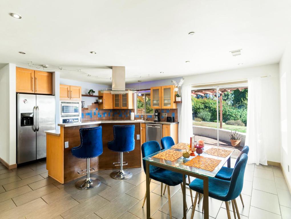 a kitchen with a table and blue chairs at Luxury Executive Home in Redlands