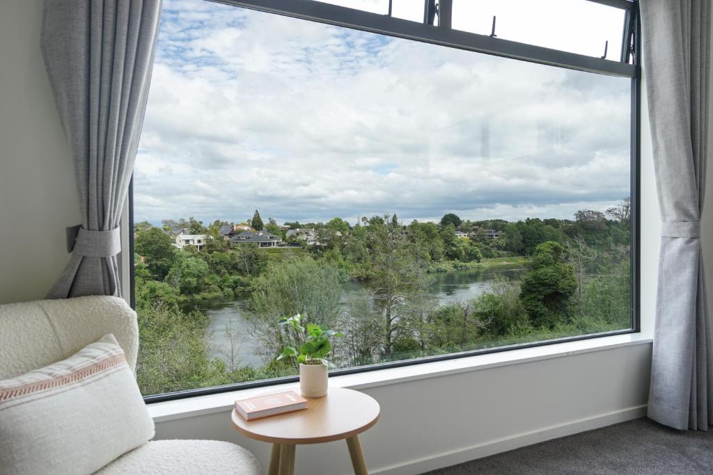 Cette chambre dispose d'une grande fenêtre offrant une vue sur la rivière. dans l'établissement Experience The Magic of Riverside Living - 5 beds, à Hamilton