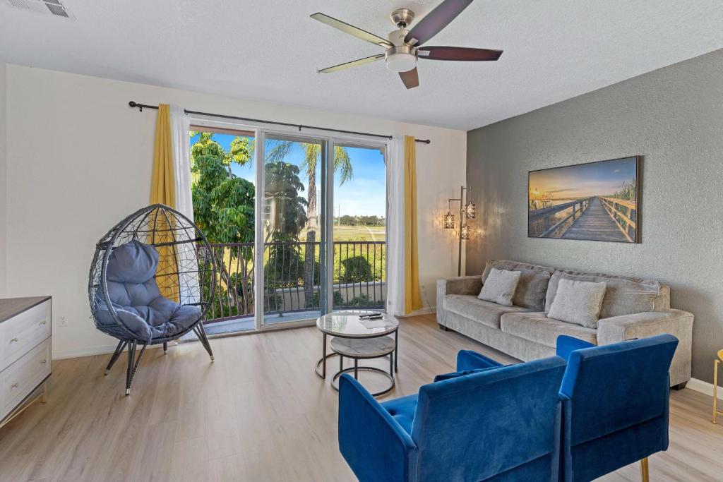 a living room with a couch and a chair at 8036 Cool Breeze Drive 133 in Orlando