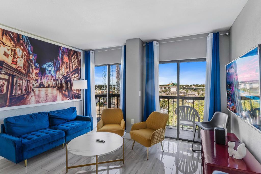 a living room with a blue couch and chairs at 6165 Carrier Drive 3805 in Orlando