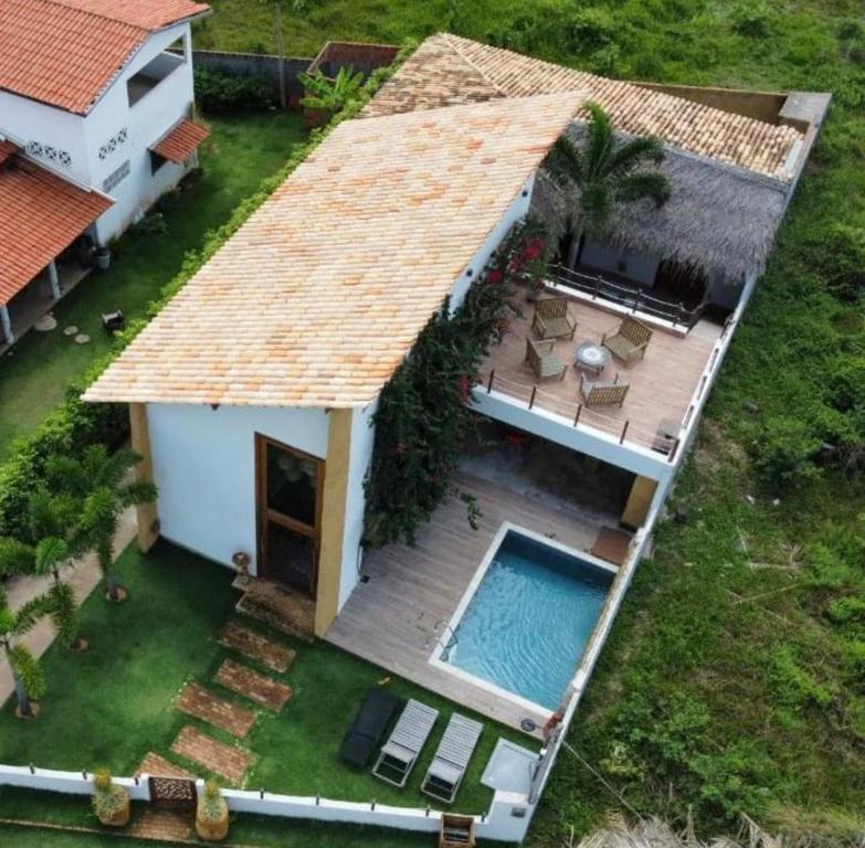 an aerial view of a house with a swimming pool at Magaral Casa de Praia in Pôrto de Pedras