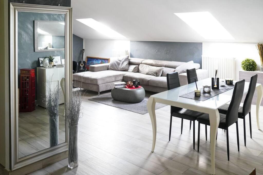 Zephyr B&B apartment في نوفي ليغوري: غرفة معيشة مع طاولة وأريكة