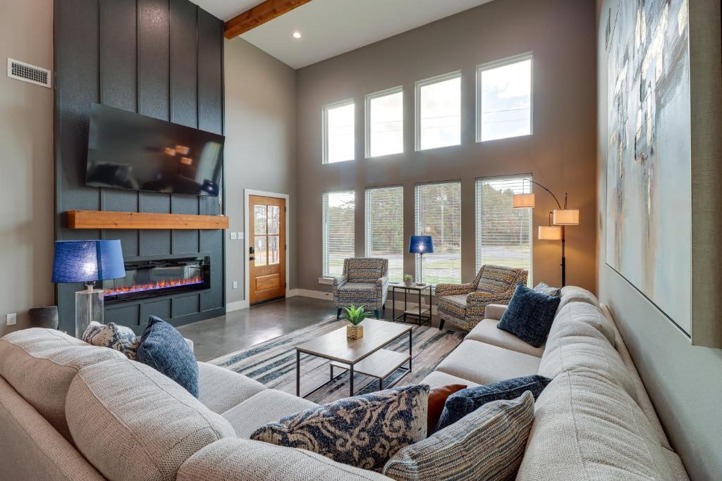 a living room with a couch and a tv at Chic Arkansas Retreat with Patio, Grill and Fire Pit! in Fairfield Bay