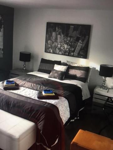 a bedroom with two beds and a picture on the wall at Le 10620 beau, grand et charmant 5 et demi in Quebec City
