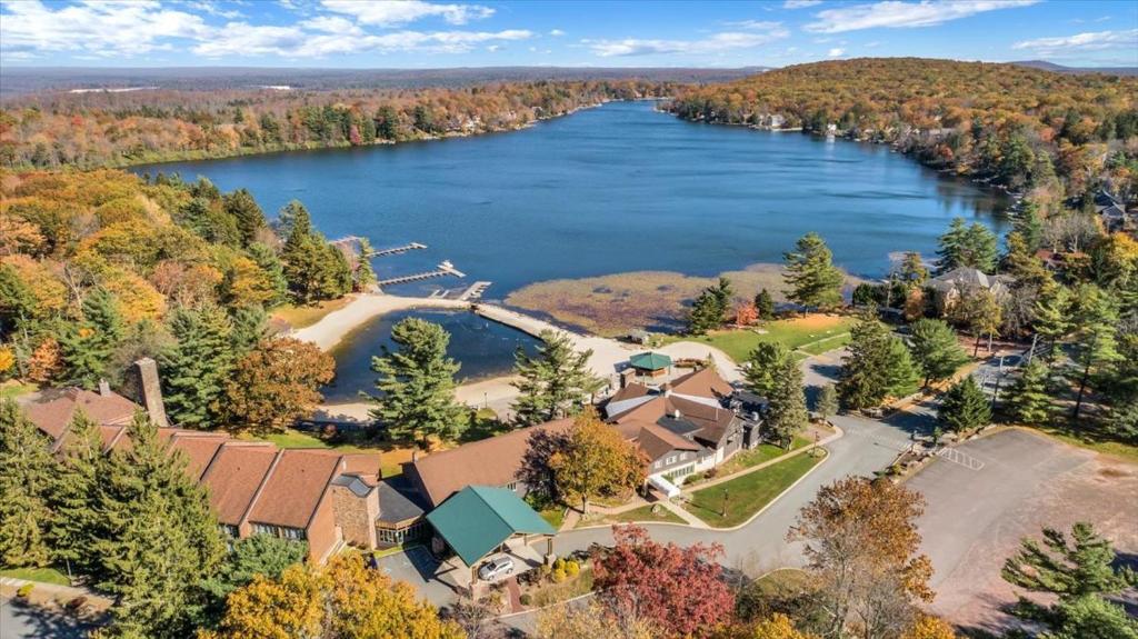 an aerial view of a house with a lake at The Lodge Luxury Resort At Lake Harmony in Lake Harmony