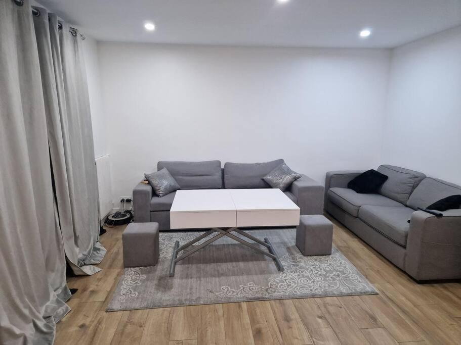 un salon avec un canapé et une table basse dans l'établissement Appartement/Apartment/전원주택 15mn from Paris RER C, à Viry-Châtillon