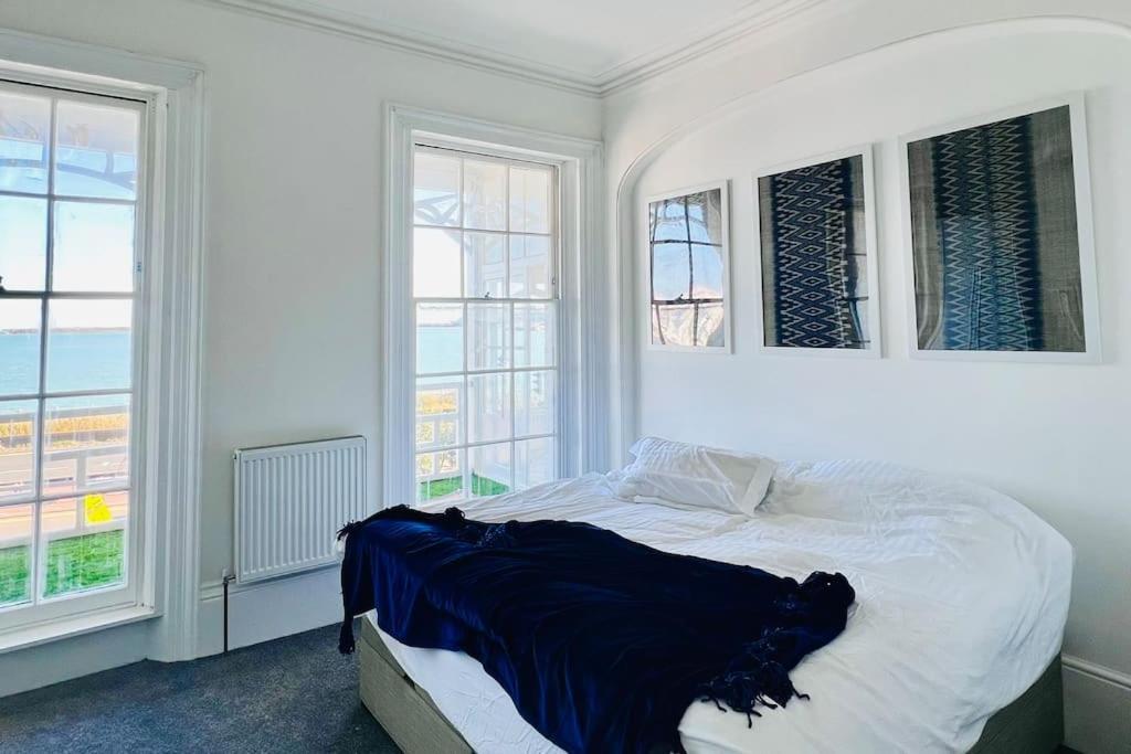 a white bedroom with a bed and two windows at Marine Parade House F4 Next to Dover Port, White Cliffs, Beach, Castle in Dover