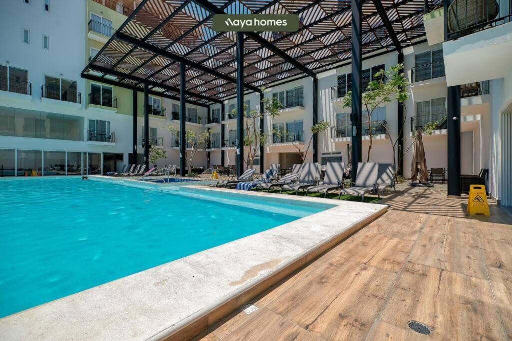 a swimming pool in the middle of a building at Cozy Studio with Private Balcony - Pool - Gym in Bucerías