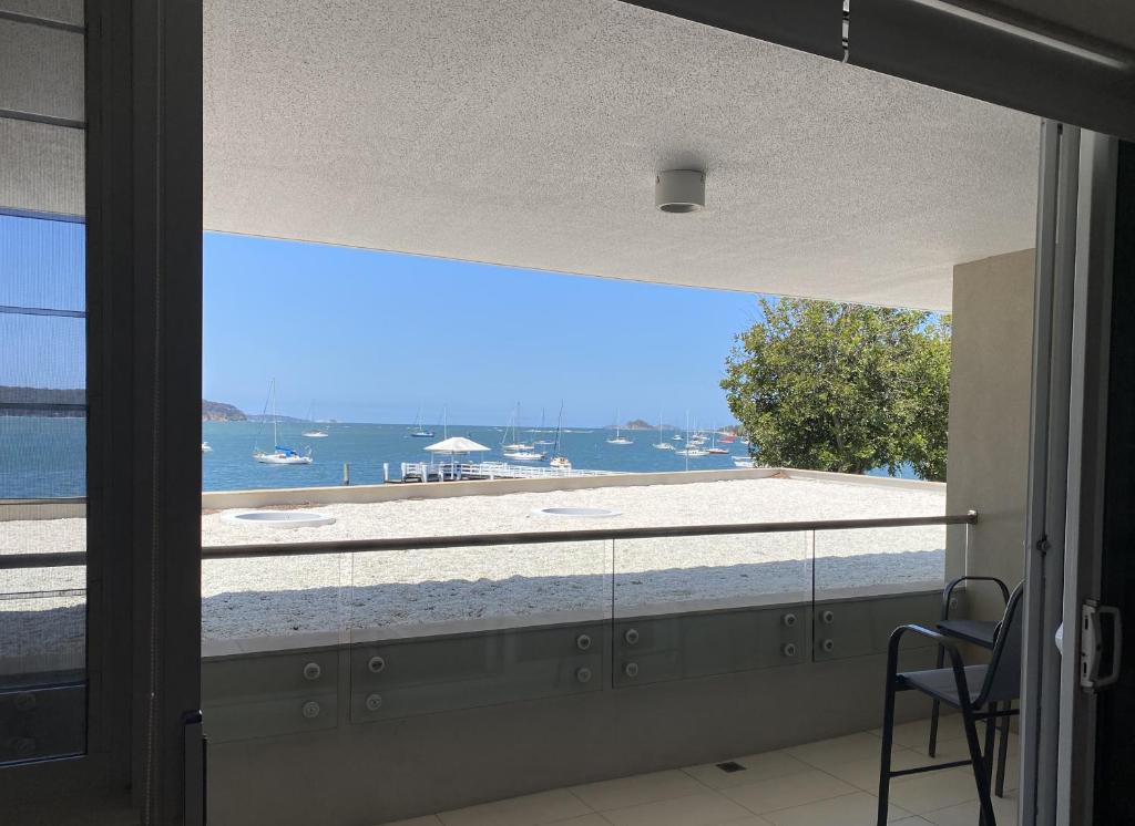 a room with a window with a view of the water at Tranquillity On The Promenade in Batemans Bay