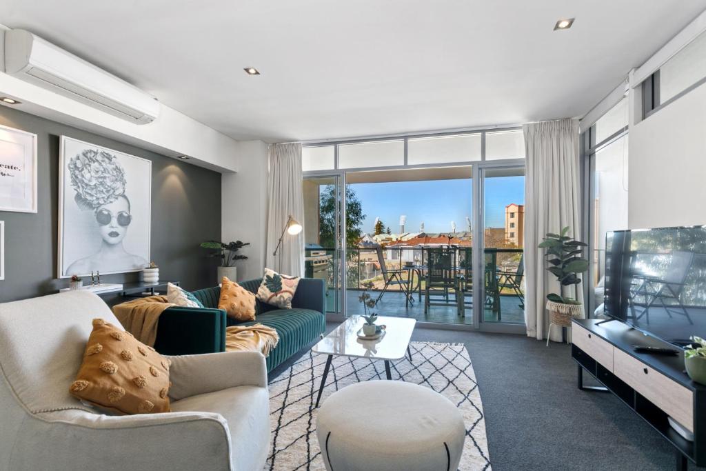 a living room with a couch and a tv at U4/51 Luxe Chic in Perth