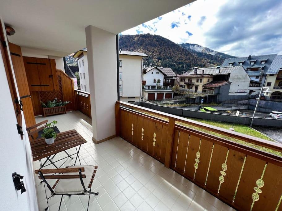 a balcony with a table and a view of a city at Civico 11 in Tarvisio