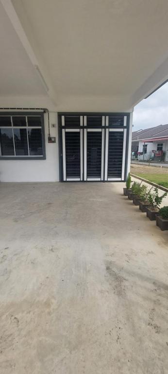 a garage with doors and windows in a house at Nz comfort house pandan kuantan in Kuantan