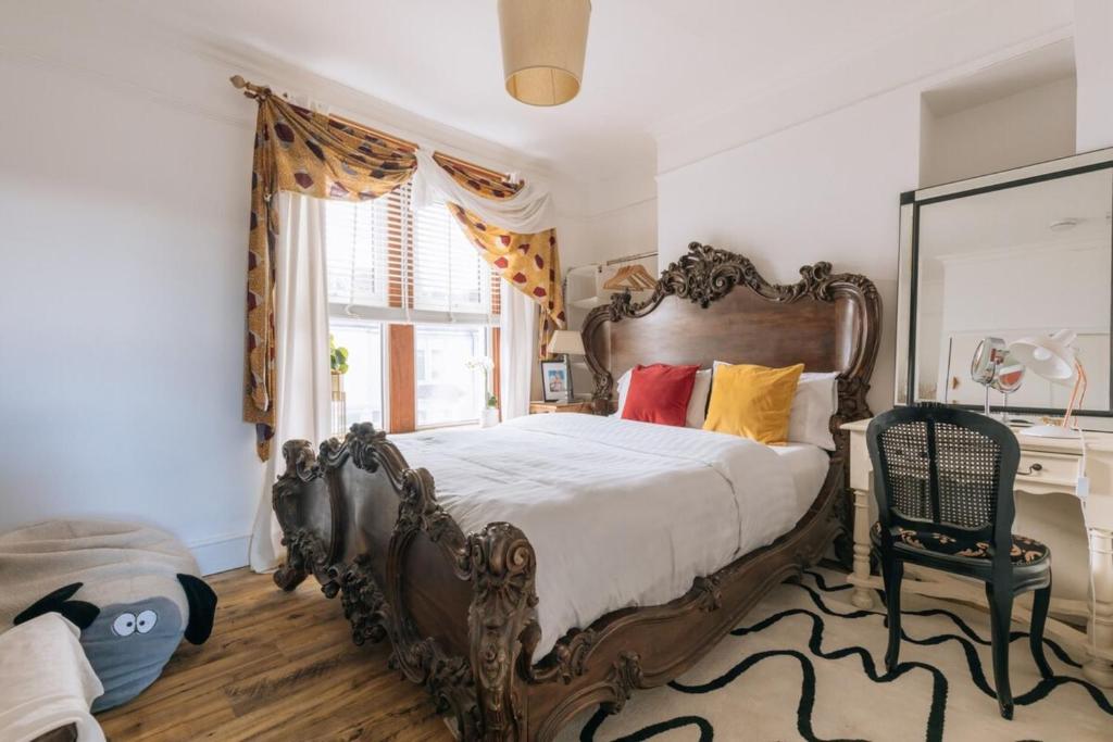 a bedroom with a large bed and a window at Vibrant & Eclectic 3 bedroom Flat - Bedminster Bristol! in Bristol