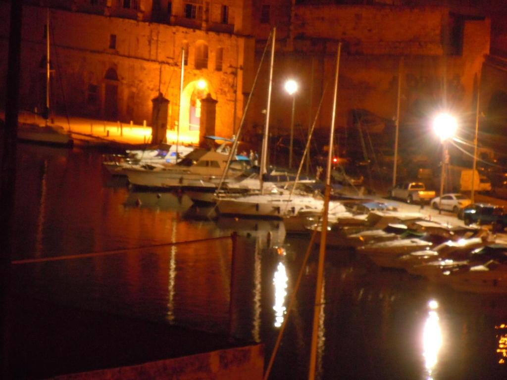 a group of boats docked in a harbor at night at Number 20 in Birgu