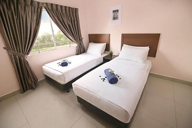 Postel nebo postele na pokoji v ubytování Sun Inns Hotel Bestari Jaya