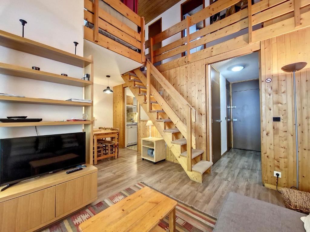 a living room with wooden walls and a staircase at Appartement Val-d'Isère, 3 pièces, 6 personnes - FR-1-518-147 in Val-d'Isère