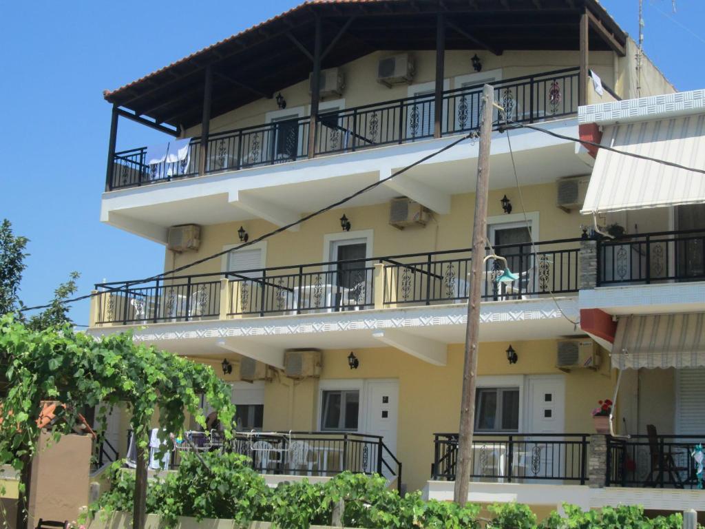 a building with balconies on the side of it at Konstantinos Beach 2 in Limenaria