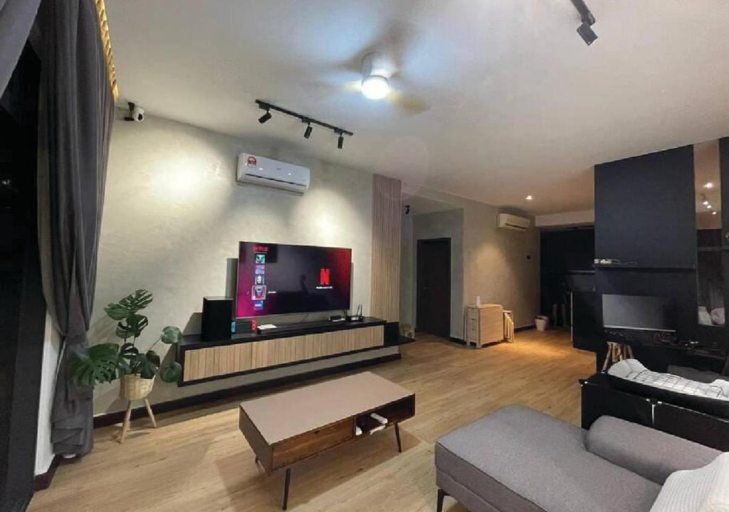 a living room with a couch and a flat screen tv at D Secret Homestay 2BR Condo Luxury in Johor Bahru