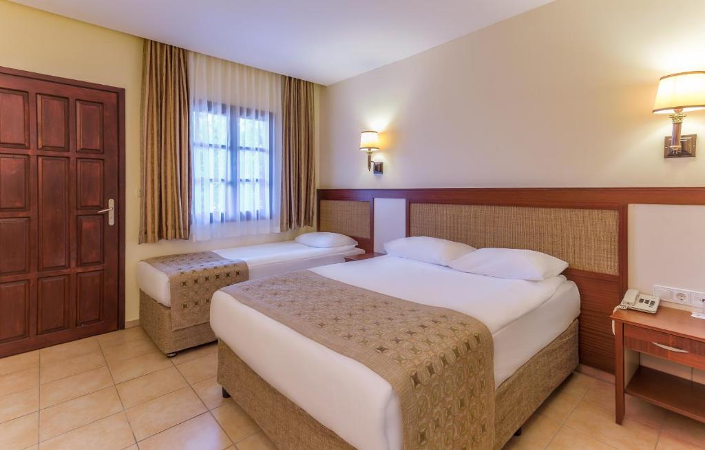 Postel nebo postele na pokoji v ubytování Ozlem Garden Hotel