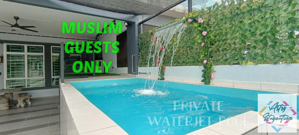 a swimming pool with a water feature in a building at Artsy Staycation in Melaka