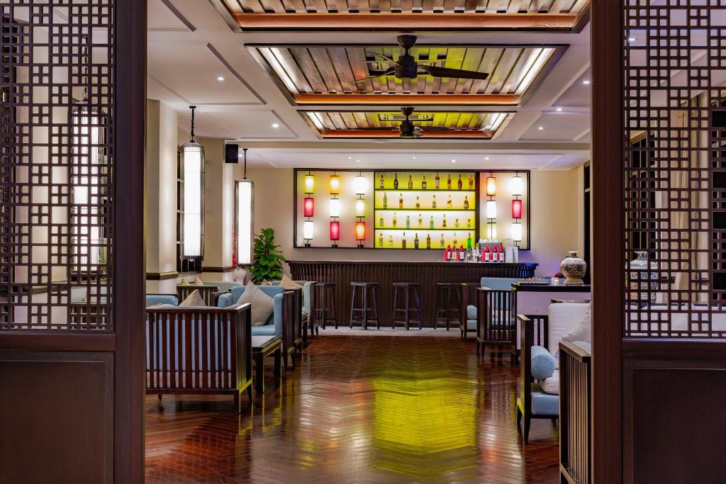 a restaurant with a bar and a lobby at Wyndham Garden Hoi An Cua Dai Beach in Hoi An