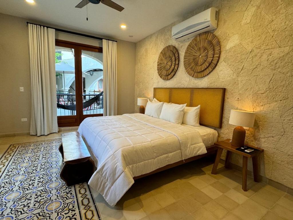A bed or beds in a room at Los Frailes Concept Hotel