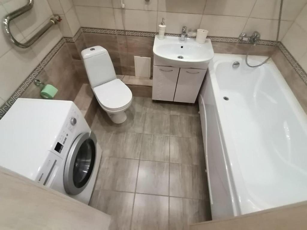 uma casa de banho com um WC, um lavatório e uma banheira em City Centre Vip Apart em Tbilisi