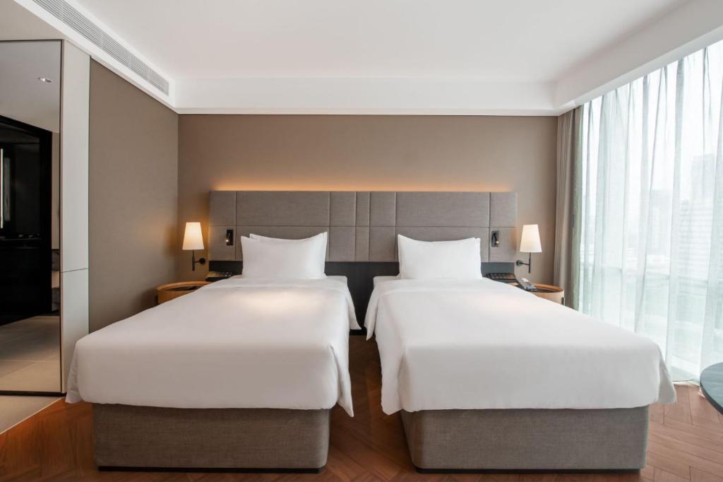 Postel nebo postele na pokoji v ubytování Intercity Hotel Futian Bin He Zhongzhou Bay