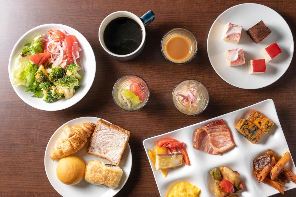 a table with plates of food and a cup of coffee at Hotel Vista Premio Kyoto Kawaramachi St in Kyoto