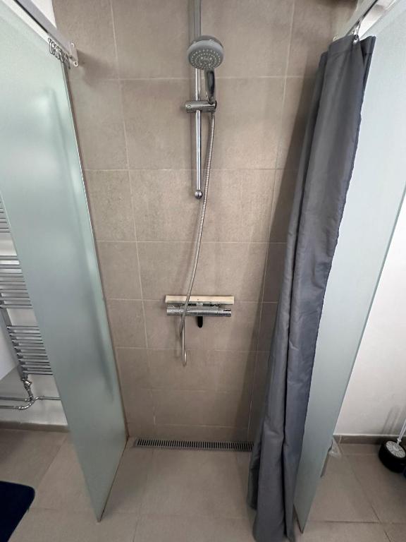 a shower in a bathroom with a shower curtain at Nice apartment in Odense in Odense
