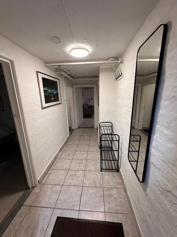 a hallway with two chairs and a mirror at Nice apartment in Odense in Odense