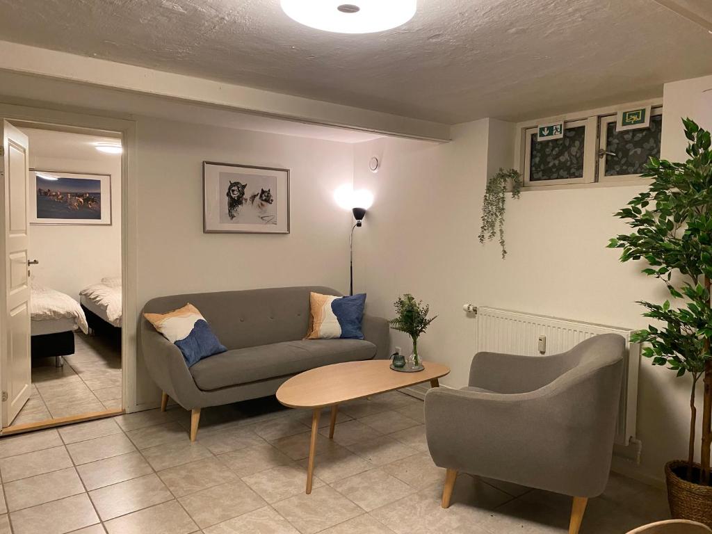 a living room with a couch and a table at Nice apartment in Odense in Odense