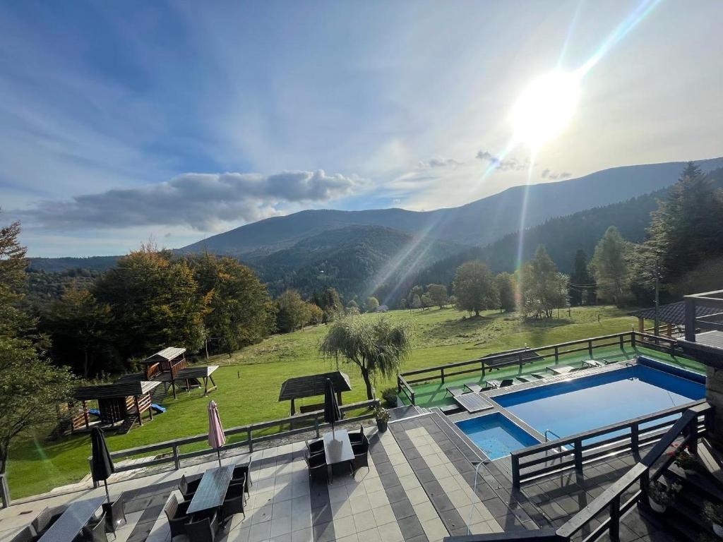 a swimming pool with a view of a mountain at Romanka in Żabnica