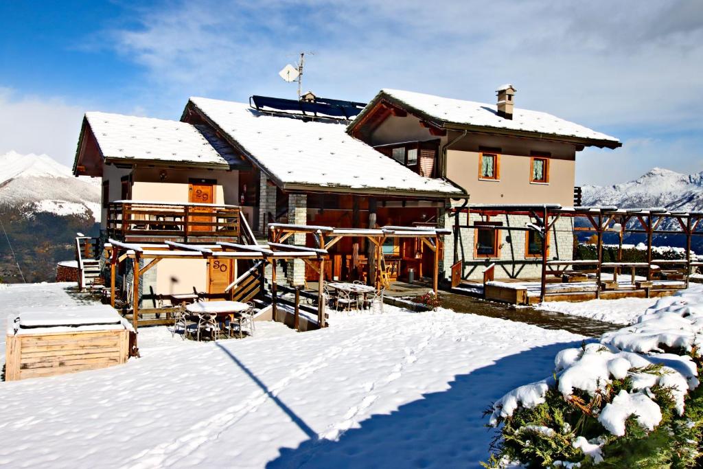 a house with snow on the roof of it at Hotel Chacaril in Pila
