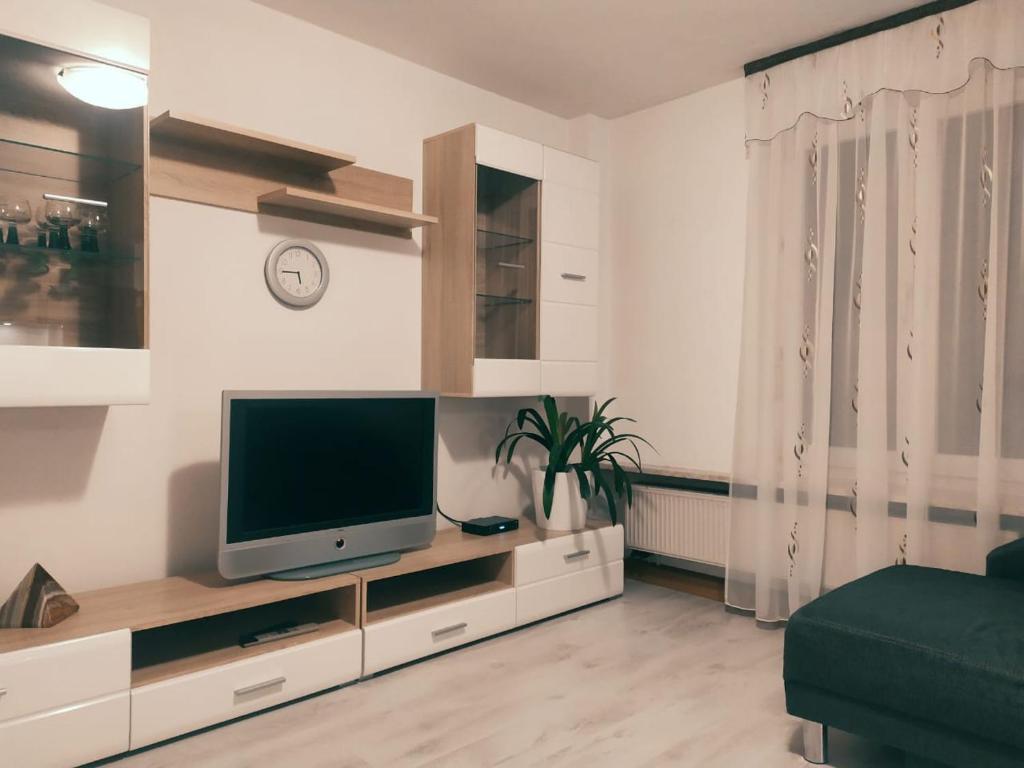 a living room with a flat screen tv on a entertainment center at Haus Mila in Freudenstadt