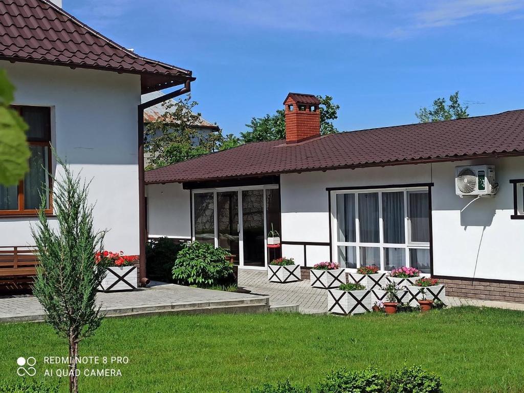 a white house with a lawn in front of it at Житловий будинок in Bilhorod-Dnistrovskyi