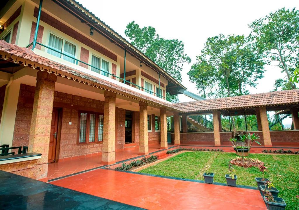an outside view of a building with a courtyard at Wild Courtyard Wayanad Resort in Wayanad