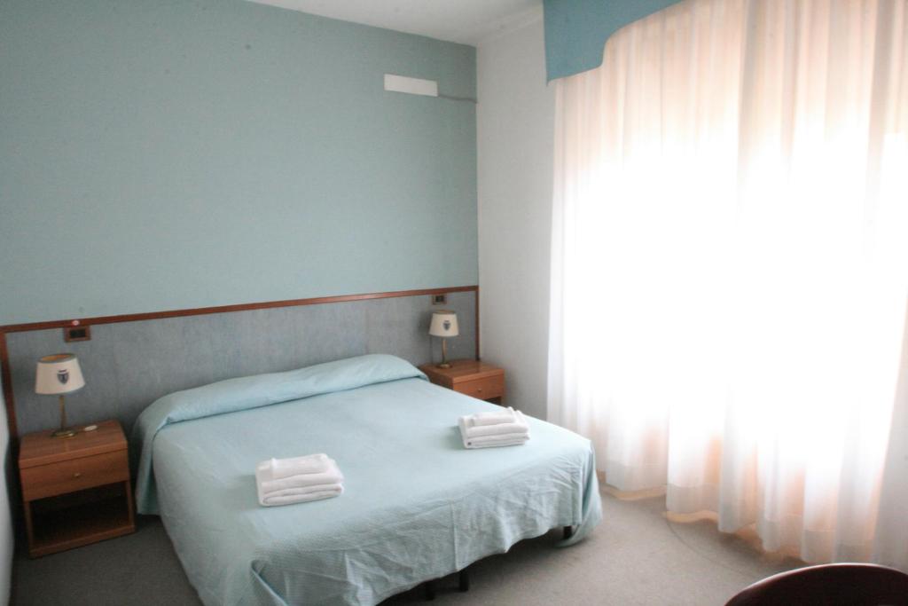 Postel nebo postele na pokoji v ubytování Hotel Redi