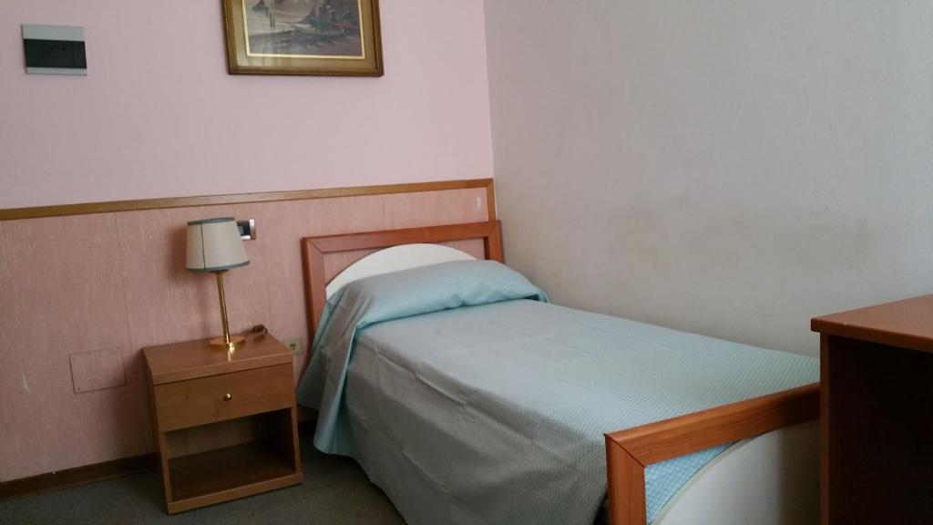 Postel nebo postele na pokoji v ubytování Hotel Redi